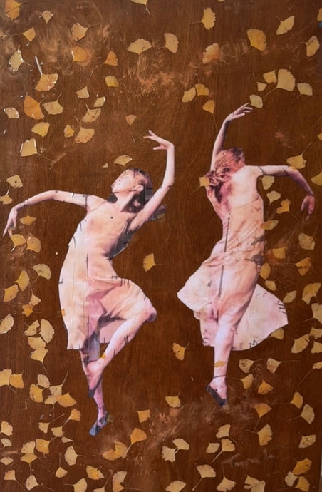 “Dance of Possibilities – original wood artwork by Mehlika Tanriverdi, featuring two women dancing among golden ginkgo leaves embedded in resin, symbolizing transformation, change, and new beginnings.”
